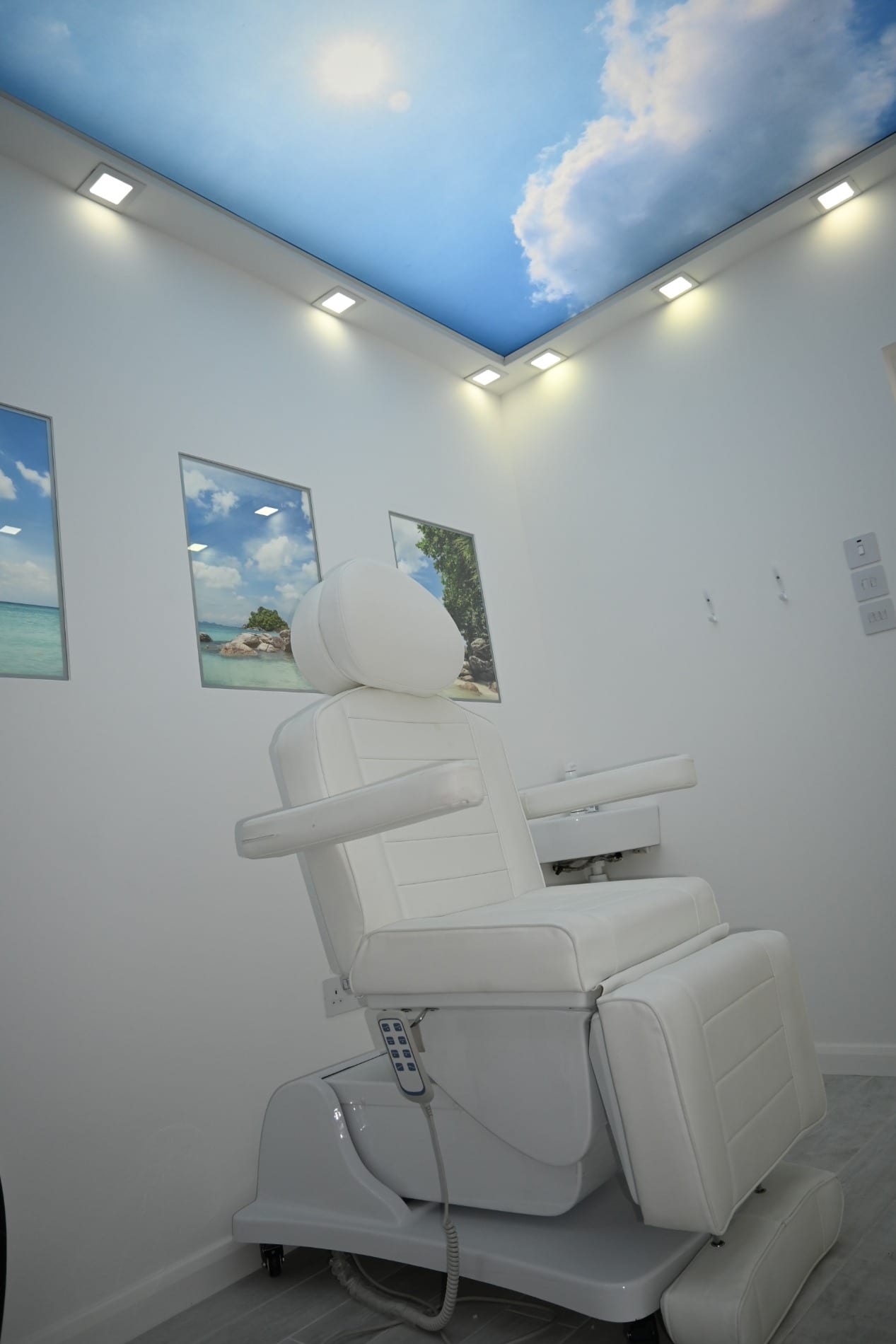 White treatment chair beneath a blue sky ceiling panel